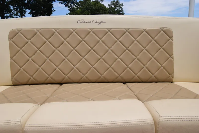 Slide: The Image of 2017 Chris-Craft Launch 25 boat seat with beige diamond-pattern upholstery. - 12