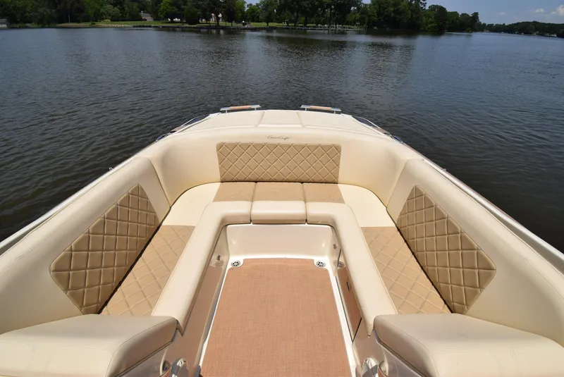 Slide: The Image of 2017 Chris-Craft Launch 25 boat interior with luxurious seating on a calm lake. - 13