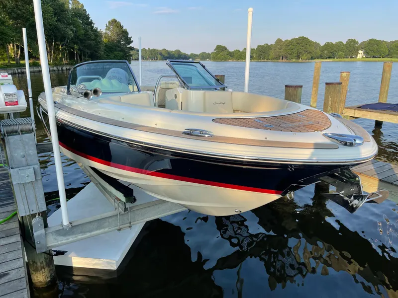 Slide: The Image of 2017 Chris-Craft Launch 25 boat docked on a serene lake. - 19