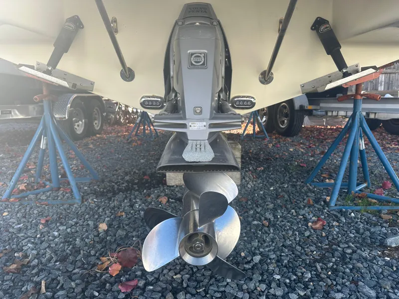 Slide: The Image of 2017 Chris-Craft Launch 25 boat propeller and stern on gravel. - 20