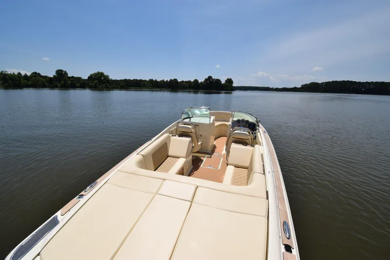 Slide: The Image of 2017 Chris-Craft Launch 25 boat on a serene lake under a clear sky. - 21