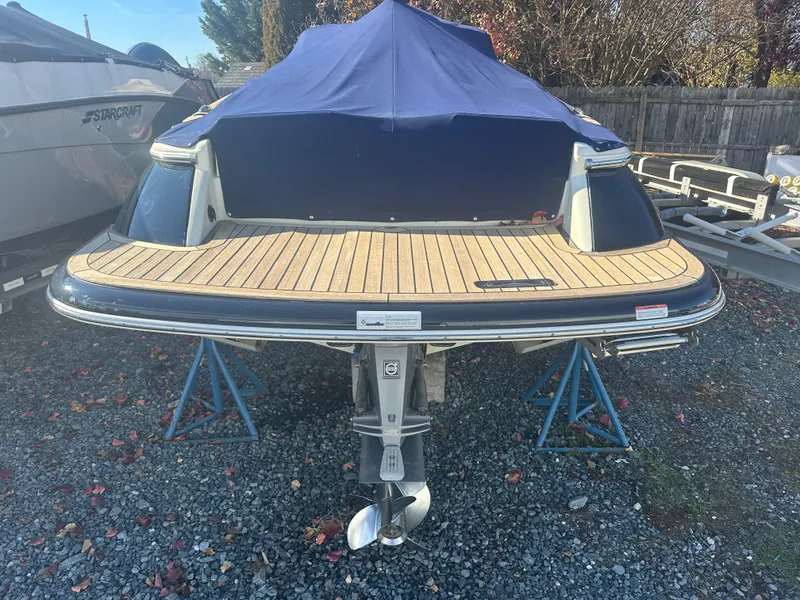 Slide: The Image of 2017 Chris-Craft Launch 25 boat with covered deck, displayed on stands. - 22