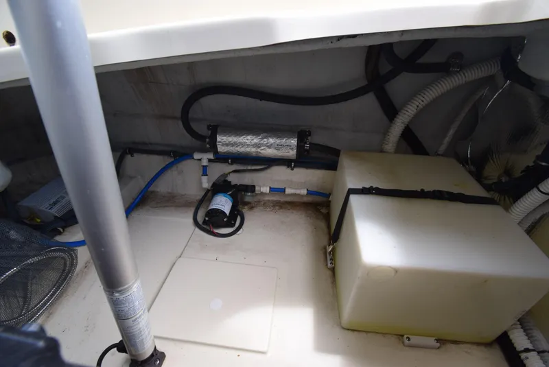 Slide: The Image of 2017 Chris-Craft Launch 25 engine compartment with pump and wiring. - 29