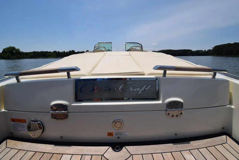 Slide: The Image of 2017 Chris-Craft Launch 25 boat on a serene lake, rear view. - 30