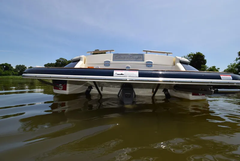 Slide: The Image of 2017 Chris-Craft Launch 25 boat on calm water, rear view. - 31