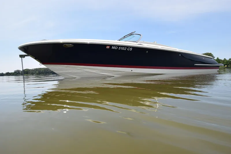 Slide: The Image of 2017 Chris-Craft Launch 25 boat on calm water, side view. - 5
