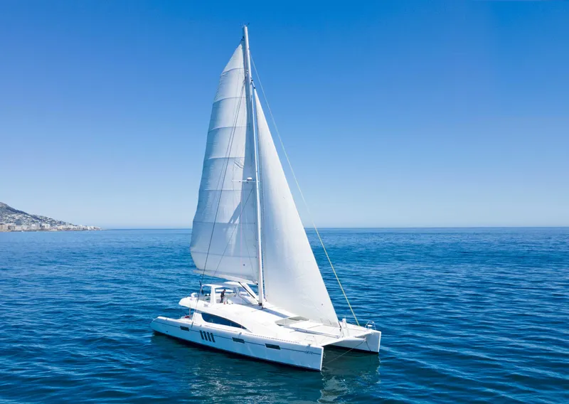 Slide: The Image of Sleek 2023 Mystique Yachts Silhouette 800 sailing on open sea under clear blue sky. - 1