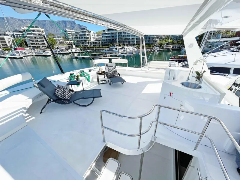 Slide: The Image of Luxurious 2023 Mystique Yachts Silhouette 800 deck with lounge chairs and marina view. - 10