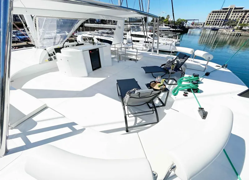 Slide: The Image of Luxurious 2023 Mystique Yachts Silhouette 800 deck with lounge chairs and marina view. - 11