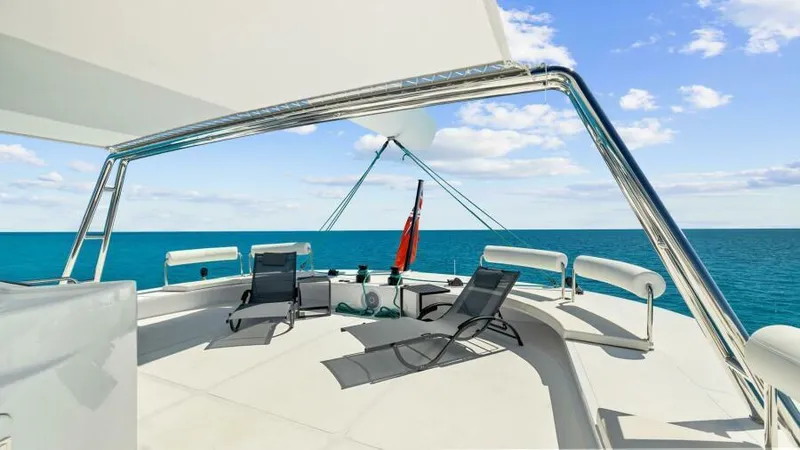 Slide: The Image of Luxurious 2023 Mystique Yachts Silhouette 800 deck with lounge chairs and ocean view. - 12