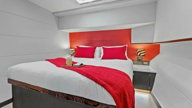 Slide: The Image of Luxurious bedroom in 2023 Mystique Yachts Silhouette 800 with red accents and modern design. - 24