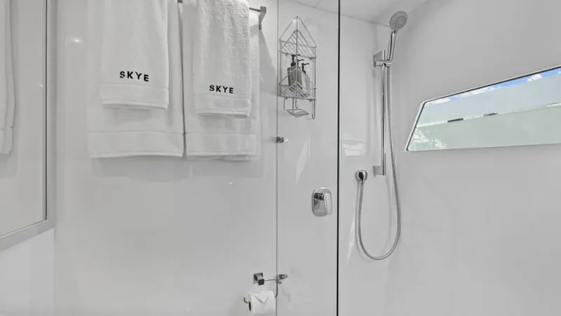 Slide: The Image of Luxurious bathroom in 2023 Mystique Yachts Silhouette 800, featuring sleek shower and elegant towels. - 25
