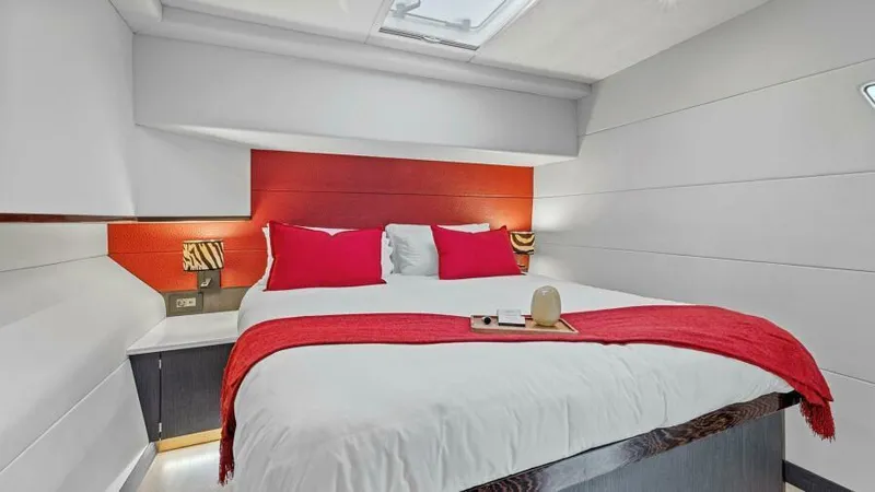 Slide: The Image of Luxurious bedroom in 2023 Mystique Yachts Silhouette 800 with modern decor and red accents. - 27