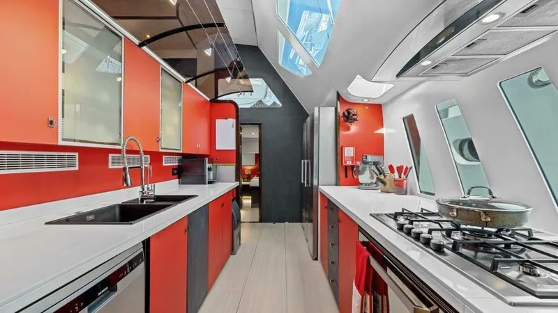 Slide: The Image of Modern kitchen interior on 2023 Mystique Yachts Silhouette 800, featuring sleek design and vibrant colors. - 28