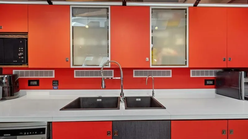 Slide: The Image of Modern kitchen on 2023 Mystique Yachts Silhouette 800 with dual sinks and vibrant orange cabinetry. - 29