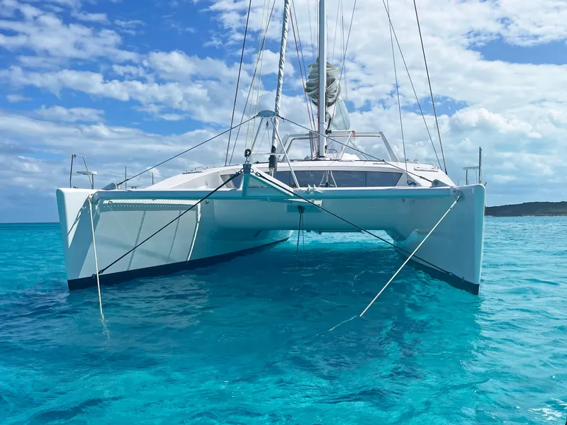 Slide: The Image of 2023 Mystique Yachts Silhouette 800 catamaran on clear blue water under a sunny sky. - 5