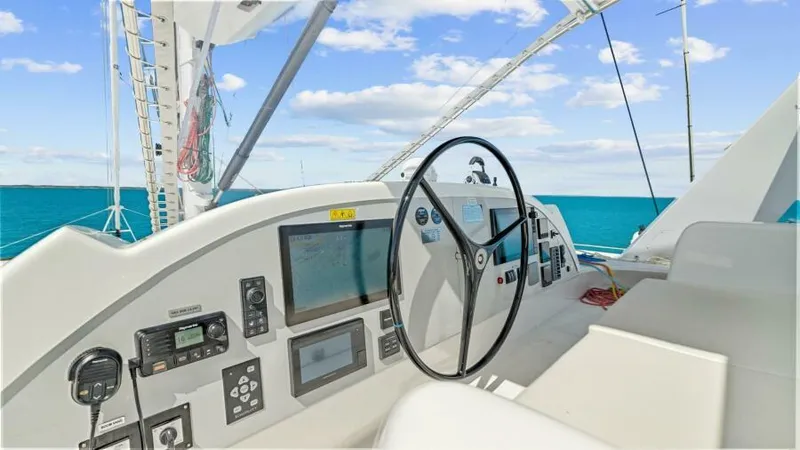 Slide: The Image of 2023 Mystique Yachts Silhouette 800 helm with navigation controls and ocean view. - 8