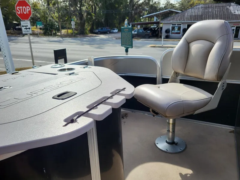 Slide: The Image of 2013 Xcursion X23RFC boat interior with seating and control panel. - 10