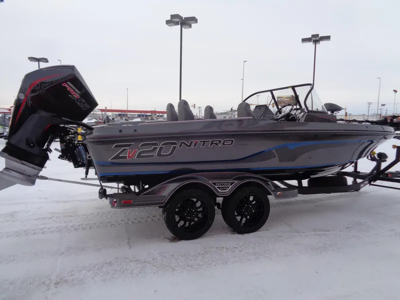 Slide: The Image of 2025 Nitro ZV20 Pro boat on snowy lot with trailer. - 3