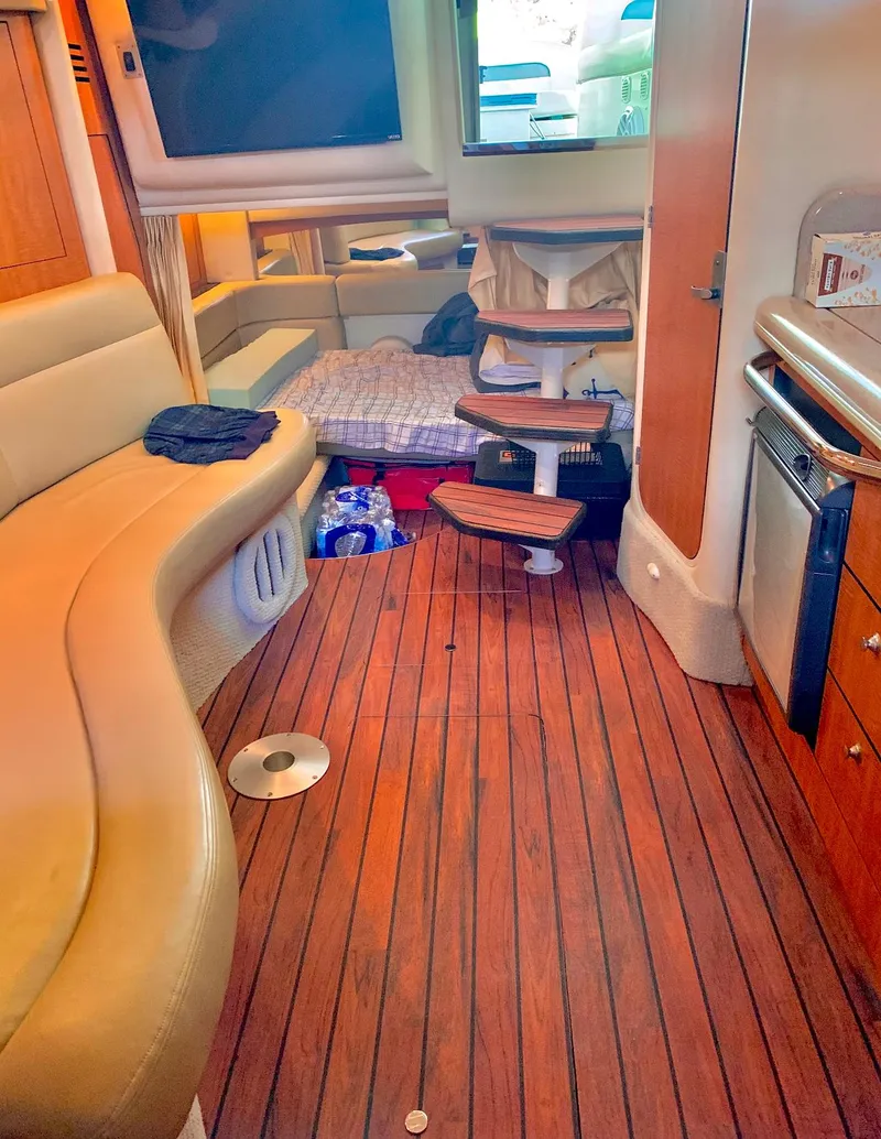 Slide: The Image of Interior of 2006 Sea Ray 320 Sundancer yacht with wooden flooring and cozy seating. - 2