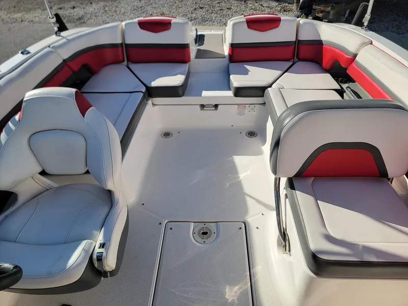 Slide: The Image of 2016 Chaparral Vortex 223 VRX boat interior with red and gray seating. - 6