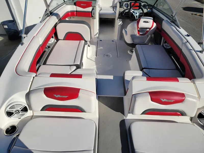 Slide: The Image of 2016 Chaparral Vortex 223 VRX interior with red and white seating, modern dashboard, and spacious layout. - 7