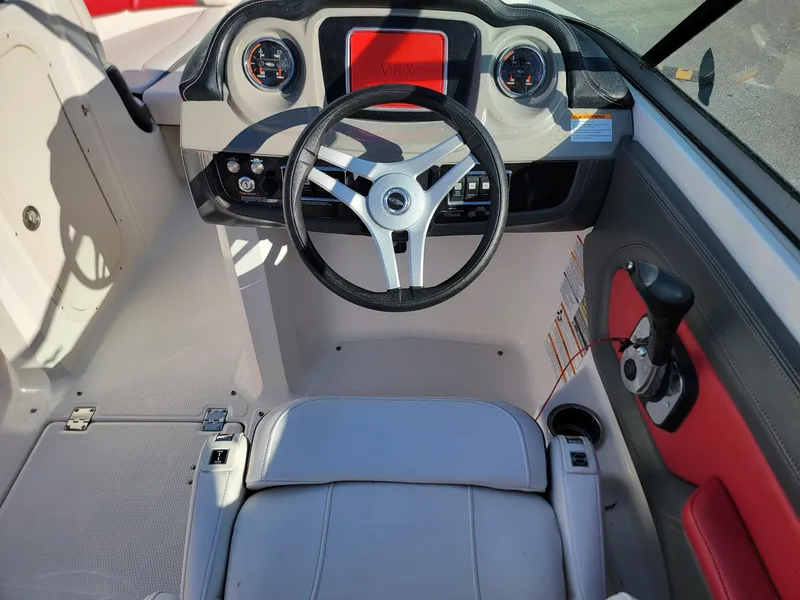 Slide: The Image of 2016 Chaparral Vortex 223 VRX boat cockpit with steering wheel and dashboard controls. - 8