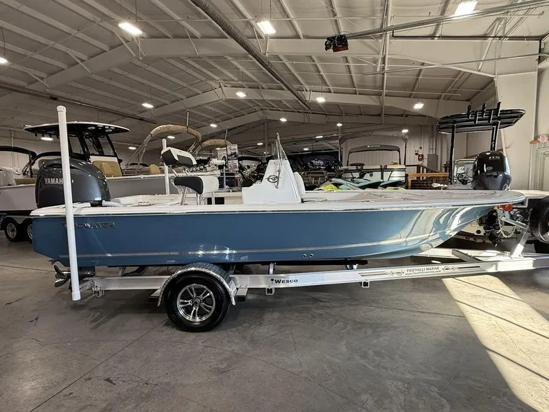 The Image of 2025 Tidewater 1910 BM boat in showroom, blue hull, on trailer. - 0