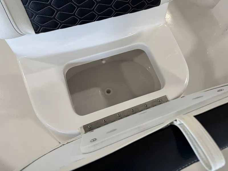Slide: The Image of Tidewater 1910 BM 2025 boat seat storage compartment with black and white upholstery. - 11