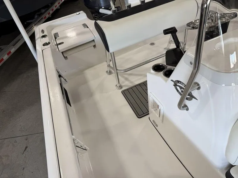 Slide: The Image of Interior view of a 2025 Tidewater 1910 BM boat, featuring seating and steering console. - 12