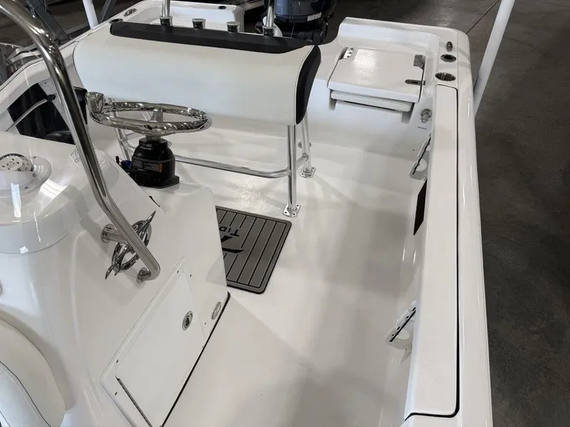 Slide: The Image of 2025 Tidewater 1910 BM boat interior with sleek white seating and modern controls. - 13