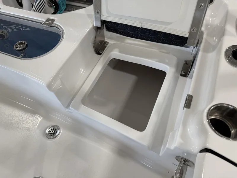 Slide: The Image of Tidewater 1910 BM 2025 boat storage compartment with open lid and cup holders. - 24