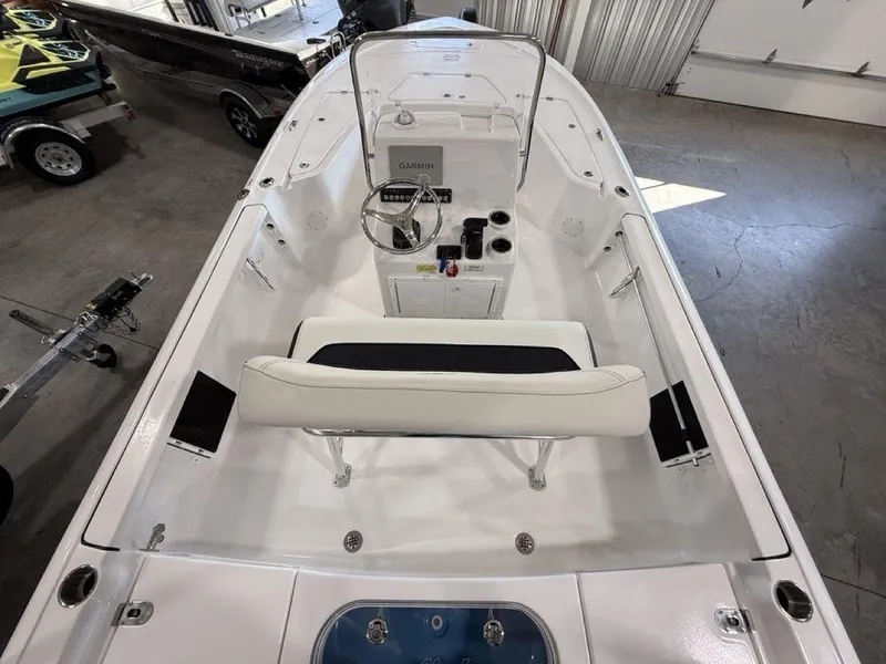 Slide: The Image of 2025 Tidewater 1910 BM boat interior with steering console and seating in a showroom. - 4