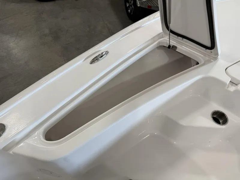 Slide: The Image of 2025 Tidewater 1910 BM boat storage compartment, open lid, white interior. - 7