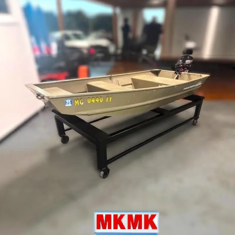 The Image of 2017 Tracker Topper 1036 Riveted Jon boat displayed indoors on a stand. - 0