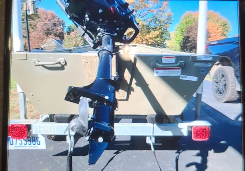Slide: The Image of 2017 Tracker Topper 1036 Riveted Jon boat on trailer with outboard motor. - 6