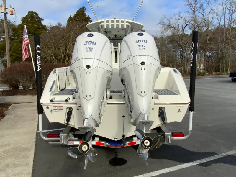 Slide: The Image of 2025 Cobia 285 Open Center Console with twin 300 V6 engines, rear view. - 10