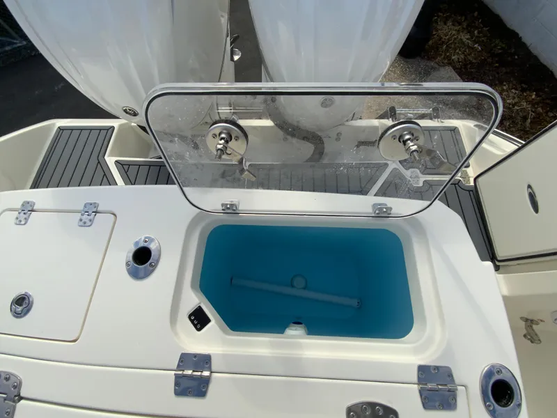 Slide: The Image of 2025 Cobia 285 Open Center Console boat with open livewell and storage compartments. - 16