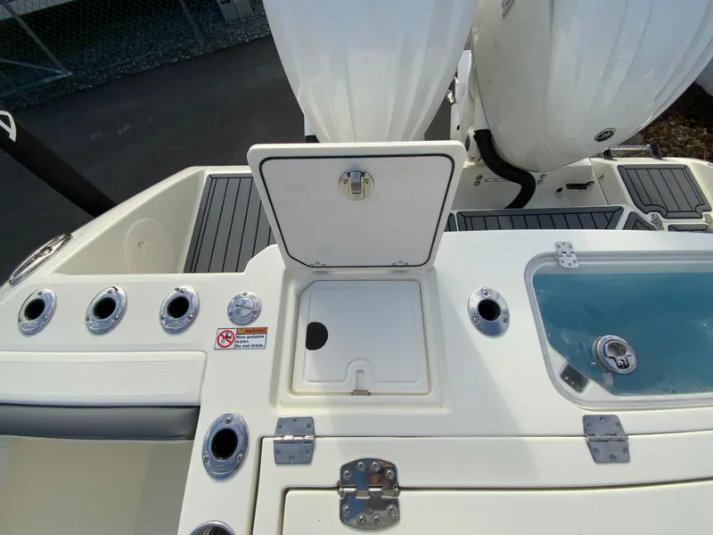 Slide: The Image of 2025 Cobia 285 Open Center Console boat deck with storage and rod holders. - 17