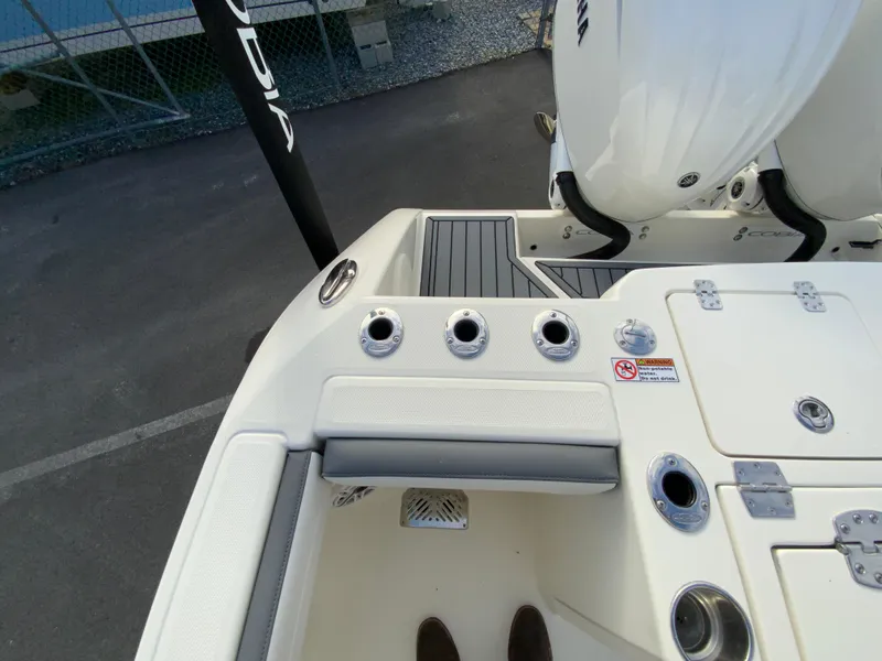 Slide: The Image of 2025 Cobia 285 Open Center Console boat deck with rod holders and seating. - 19