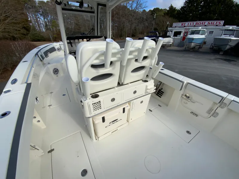 Slide: The Image of 2025 Cobia 285 Open Center Console boat interior with rod holders and storage. - 22