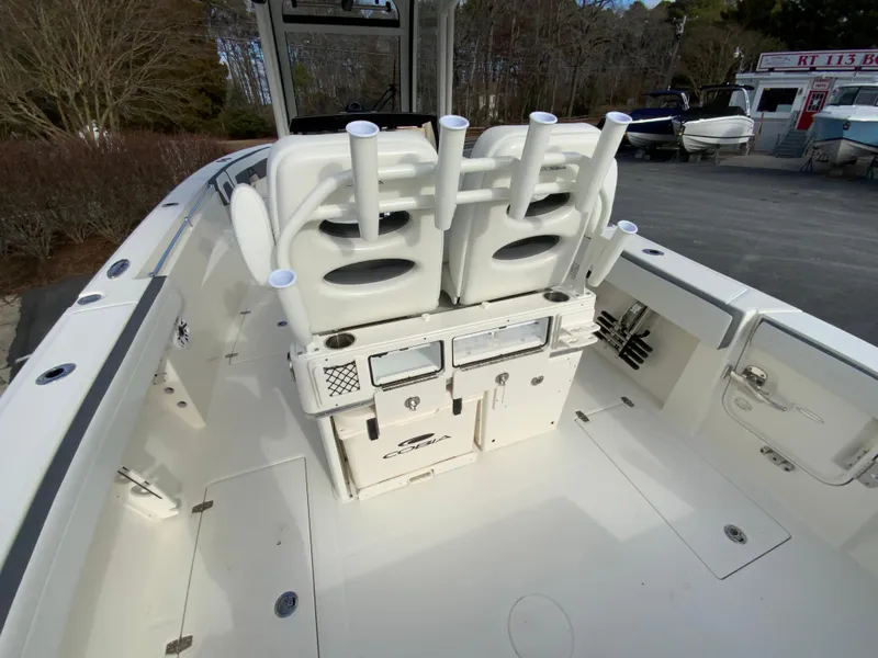 Slide: The Image of 2025 Cobia 285 Open Center Console boat interior with rod holders and storage compartments. - 23