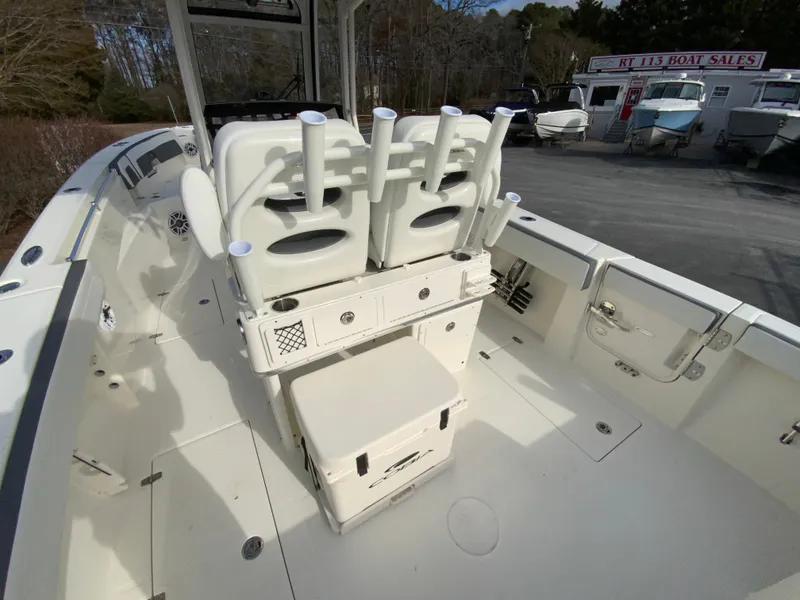 Slide: The Image of 2025 Cobia 285 Open Center Console boat interior with rod holders and storage. - 26