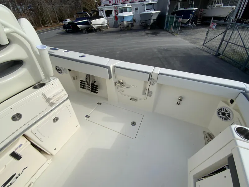 Slide: The Image of 2025 Cobia 285 Open Center Console boat interior, featuring spacious deck and storage compartments. - 27
