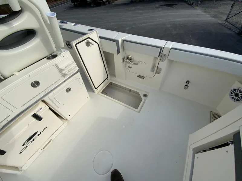 Slide: The Image of 2025 Cobia 285 Open Center Console boat interior with storage compartments. - 32