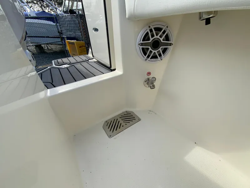 Slide: The Image of 2025 Cobia 285 Open Center Console interior with speaker and drain. - 38