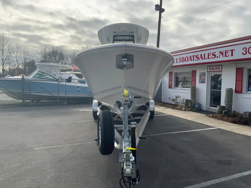 Slide: The Image of 2025 Cobia 285 Open Center Console boat on trailer at dealership. - 4