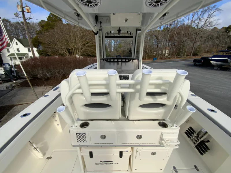 Slide: The Image of 2025 Cobia 285 Open Center Console boat interior with rod holders and storage. - 40