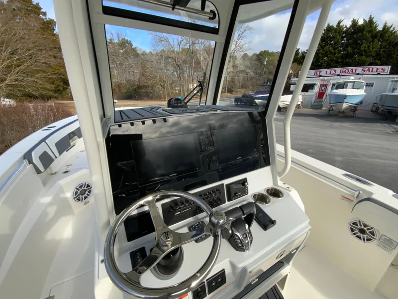Slide: The Image of 2025 Cobia 285 Open Center Console boat dashboard with steering wheel and controls. - 46
