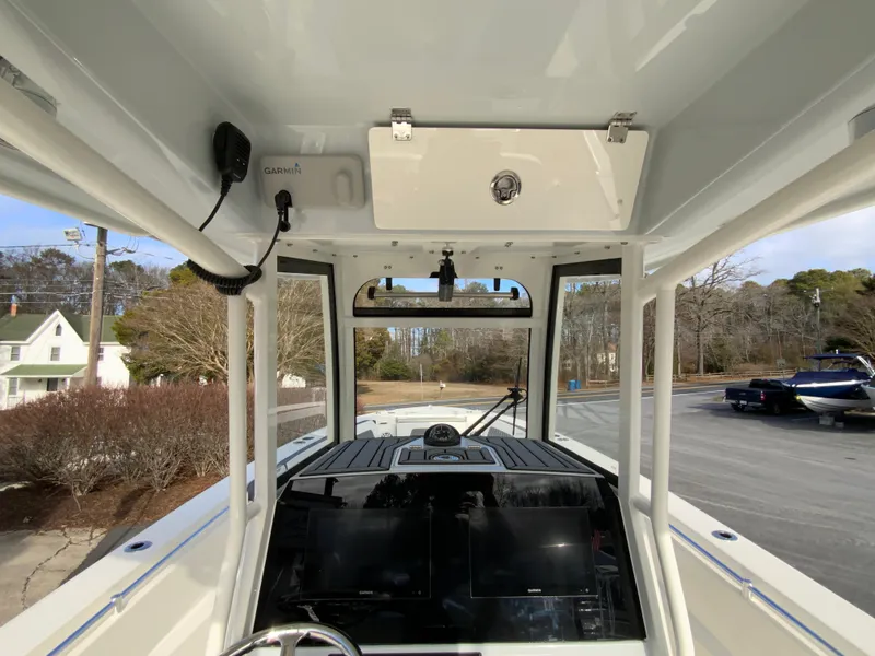 Slide: The Image of 2025 Cobia 285 Open Center Console boat interior with modern dashboard and controls. - 47